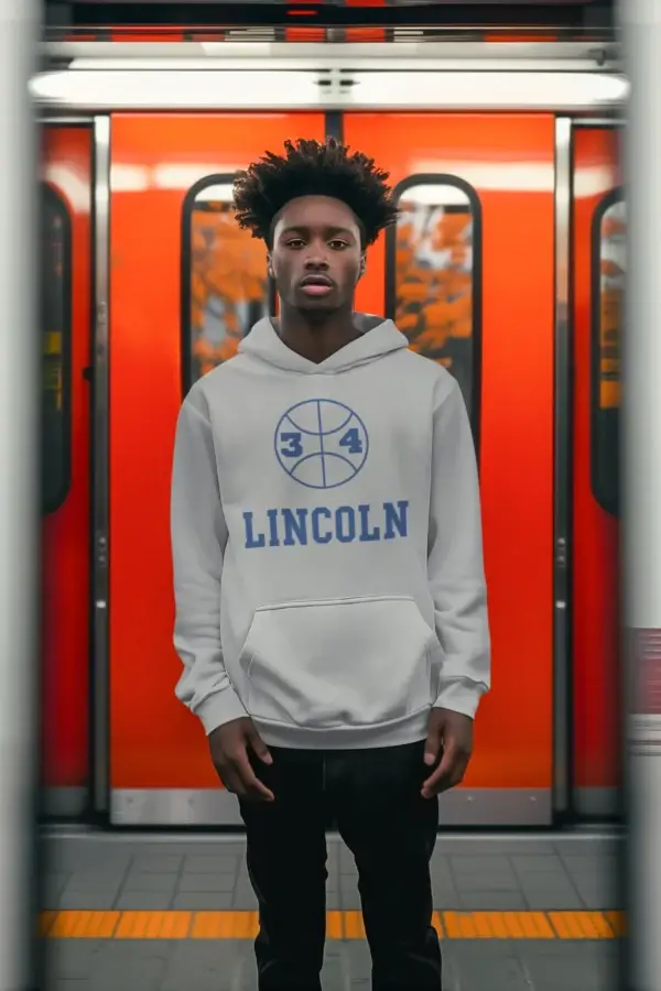 Young man on subway wearing a gray Lincoln High - Jesus Shuttlesworth Fleece Hoodie