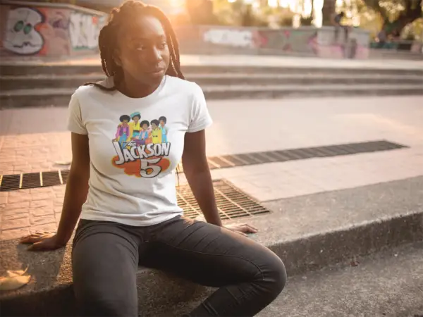 Young man with dreads wearing a white Jackson5 Retro Cartoon Triblend T-Shirt