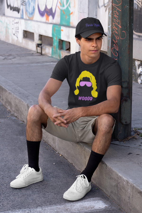 Young man with a black Florida Nights Apparel hat, wearing a black Ric Flair Woooo t-shirt