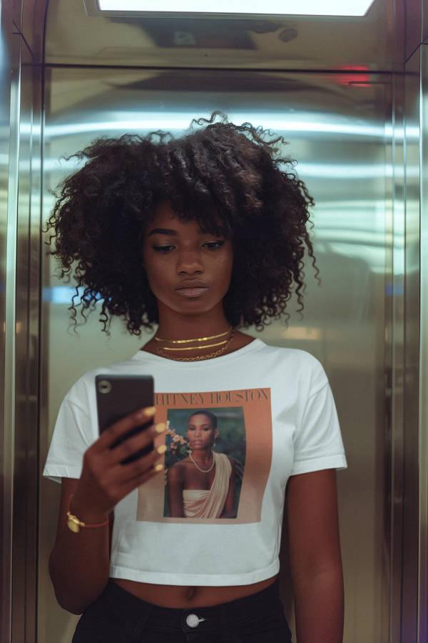 Young lady wearing White Whitney Houston Queen Crop Tee