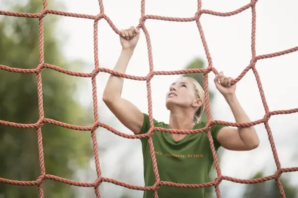 Model wearing a military green triblend t-shirt with the bold Who Dares Win; design, styled casually to highlight its luxurious look and comfortable fit, available in sizes S-3XL