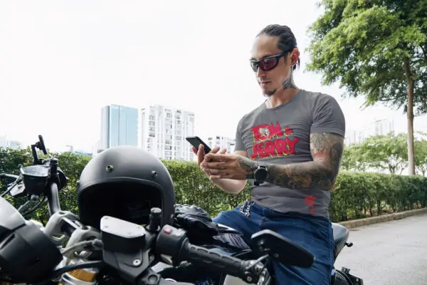 Man on motorcycle wearing a gray Tom & Jerry Triblend T-Shirt