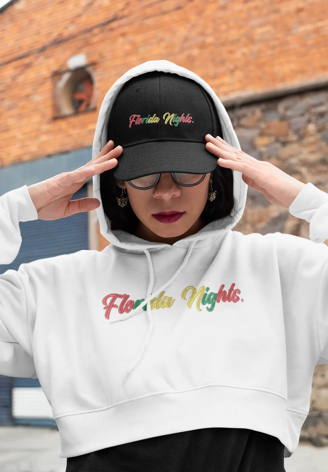 Young lady wearing a black Florida Nights hat and a white Florida Nights hoodie